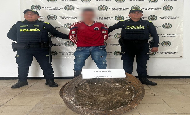 Dos policias con un capturado y elemento recuperado