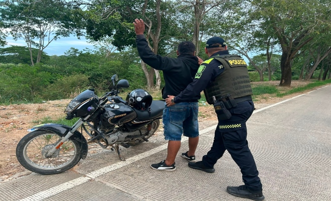 un uniformado de la Policía nacional realiza registro a una persona  