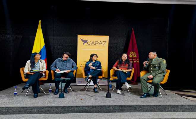 Tres mujeres un hombre y un polícia sentados.