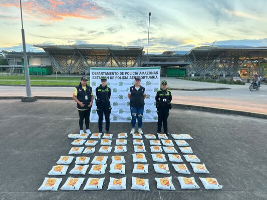 Cuatro personas, entre ellas 2 Polic&iacute;as, posando frente a las instalaciones de la estaci&oacute;n policial en Amazonas, con una gran cantidad de paquetes dispuestos en el suelo, correspondientes a sustancias il&iacute;citas que fueron incautadas durante una operaci&oacute;n de control y seguridad