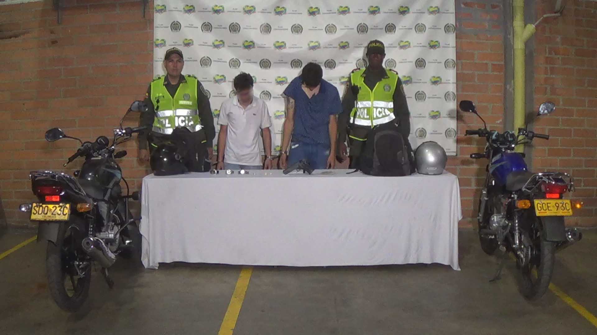 Capturados dos fleteros en Medellín Dos personas capturadas custodiados por dos policías de la Sijin