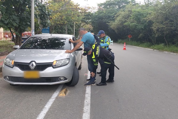 Policía realizando registro a persona en la ruta 45 con el acompañamiento de un agente de transito