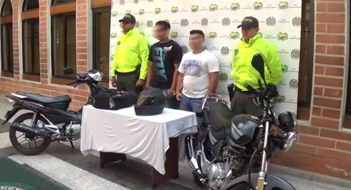 Capturados dos fleteros en Medellín Dos personas capturadas custodiados por dos policías de la Sijin
